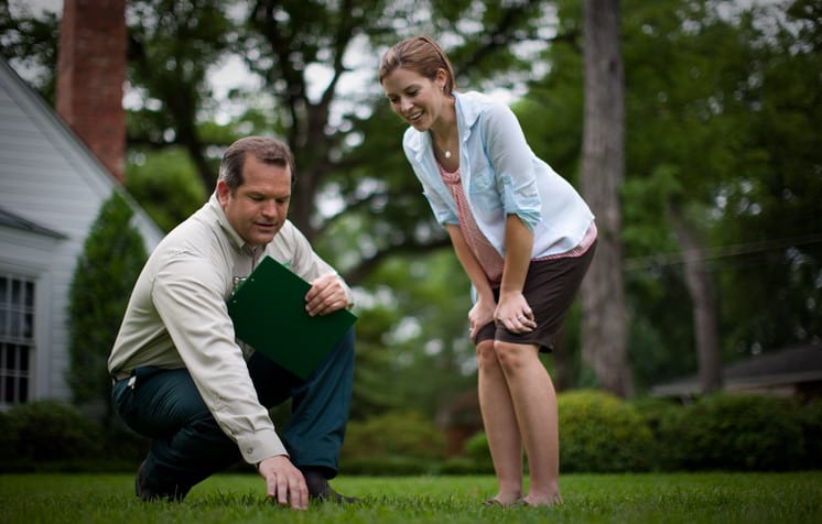 landscape architect explaining lawn aeration to a lady