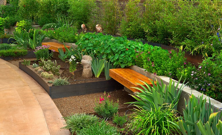 beautifully landscaped backyard with garden bench